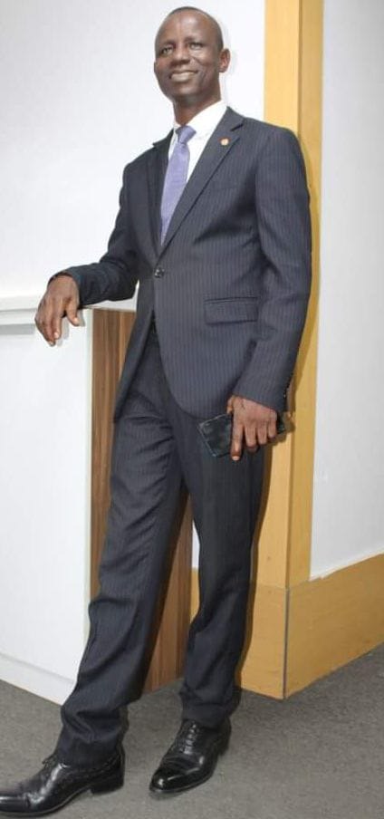 Prof. Ogunsakin-Akin in a pinstriped navy suit